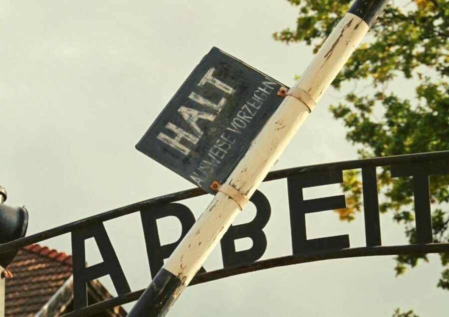 From Warsaw: Auschwitz-Birkenau Small Group Tour with Lunch - Entering Auschwitz I through the famous gate